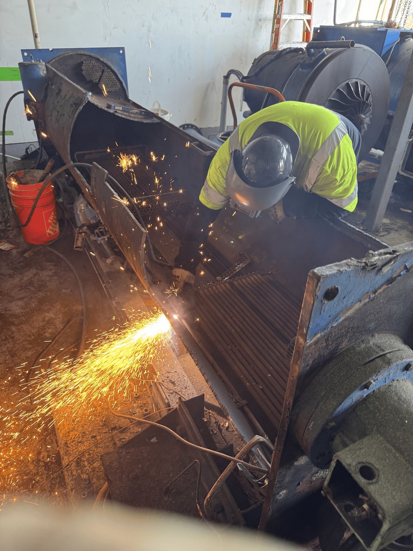 Worker torch-cutting scrap metal at the C4S Recycling yard Worker torch-cutting scrap metal at the C4S Recycling yard
